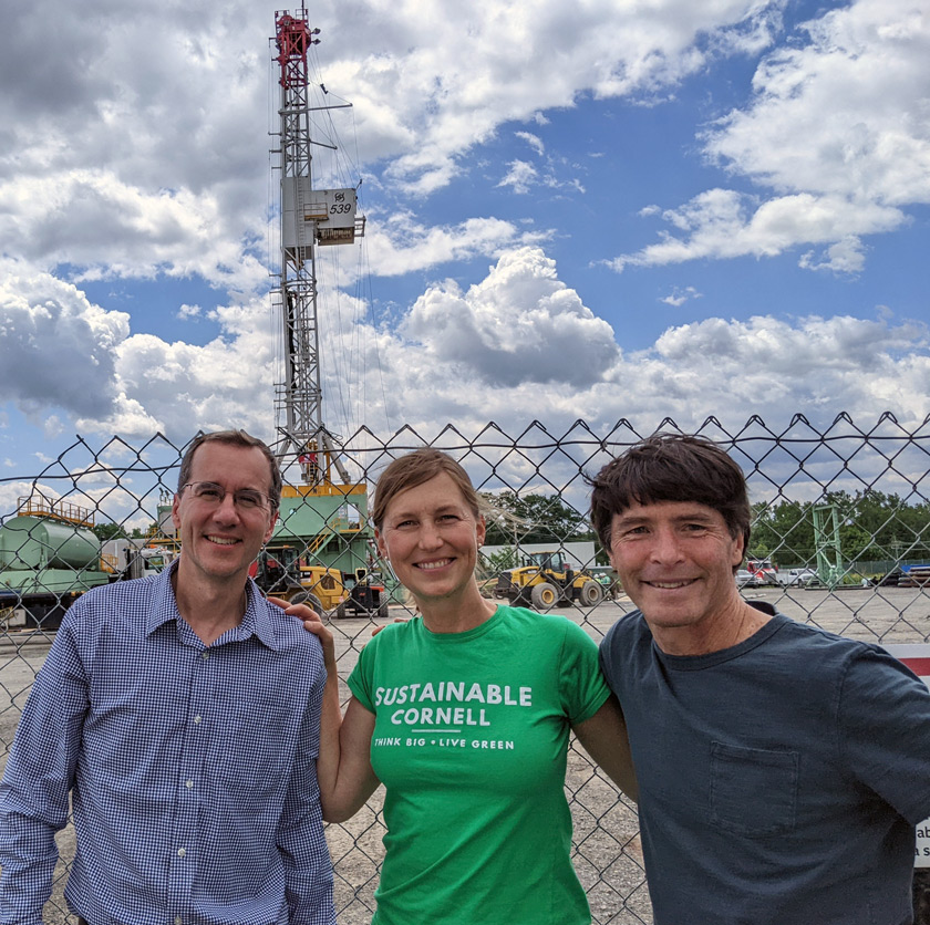 Mark Howe, former director of Utility Distribution and Energy Management, Sarah Carson, and Steve Beyers, energy specialist, in front of the Cornell University Borehole Observatory in summer 2022. 