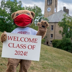 Big red bear welcomes students to campus during COVID, wearing a mask