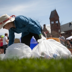 Picking up water bottles to recycle them on Slope Day
