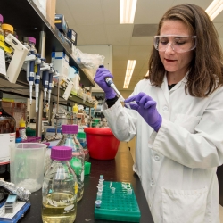 Woman holding pipette in lab