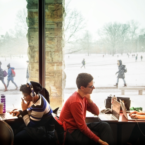 Students stay warm as they study in Olin Library during a snowstorm.  Credit: Jason Koski
