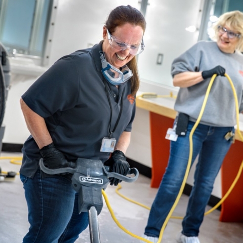 Custodian Patty Armstrong runs a rotary scrubber