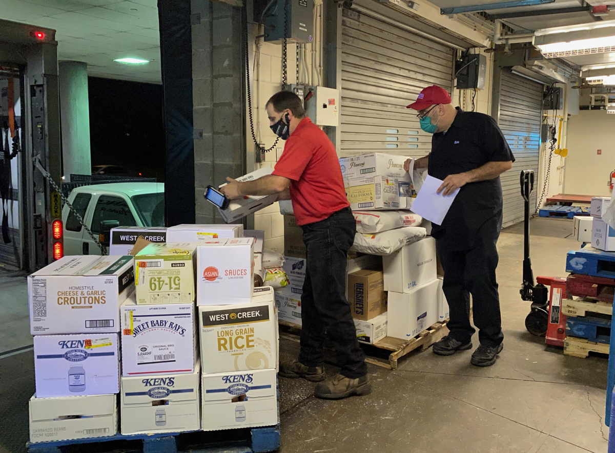 Bob Bushey from PFG and Eric Moyer from Cornell Dining unload a food delivery for North Star Dining Room at the Appel Commons loading dock.