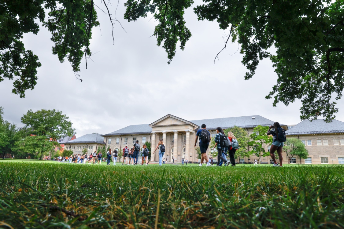 Students pass Goldwin-Smith Hall on the Arts Quad